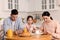 Internet addiction. Family with smartphones at table in kitchen