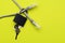Internet cable passing through a closed iron lock with keys on a yellow background concept data protection