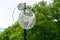 Internet outdoor wireless antenna metal rod on the roof and green tree and sky in the background