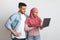 Internet Scams. Confused Young Muslim Couple Looking At Laptop Screen With Worry