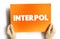 Interpol - international organization that facilitates worldwide police cooperation and crime control, text concept on card
