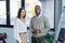 interracial businessman and businesswoman posing in