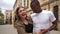 Interracial couple, black man and white woman. Mixed race couple, inreraras friends dance in the middle of a city street