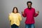 Interracial couple in knitted sweaters on grey background