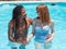 Interracial couple in love, play in the pool. The girl very white and red hair and the boy black