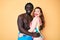 Interracial couple wearing swimwear with a happy and cool smile on face