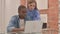 Interracial Couple Working on Laptop at Home