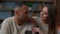 Interracial married couple spouses multiracial ethnic hispanic woman and african american man look at cellphone screen