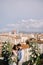 Interracial wedding couple. Destination fine-art wedding in Florence, Italy. A wedding ceremony on the roof of the