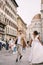 Interracial wedding couple. Wedding in Florence, Italy. African-American bride and Caucasian groom run along Piazza del