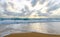 Intersecting sea waves in the sand during sunset on the shore of a solitary island