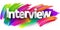 Interview paper word sign with colorful spectrum paint brush strokes over white