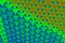 Interwoven rainbow background pattern in orange, blue and green