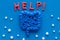 Intestines illness and treatment. Word help near guts and pills on blue background top view