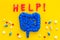 Intestines illness and treatment. Word help near guts and pills on yellow background top view