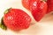 Intimate close-up view of vibrant ripe strawberries on dark background