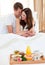 Intimate couple having breakfast lying in bed