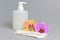 Intimate gel dispenser pump plastic bottle, sanitary towel, flowers on gray