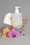 Intimate gel dispenser pump plastic bottle, sanitary towel in pushcart with orchid flowers