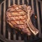 Intimate grill moment Close up of succulent beef tomahawk steak searing