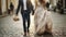 Intimate Moments - The bride and groom goes ahead on the pavement and walking, holding hands on a stroll along the street in the