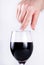 Intoxicating Elegance: Woman\\\'s Finger Gracefully Touches Red Wine Glasses