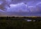 Intracloud lightning thunderbolt IC strikes at night above a city