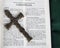 Intricate antique cross with Corinthians verse in Holy Bible