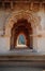 Intricate carvings on the arched hallway Lotus Mahal Temple in Hampi, Karnataka, India. Beautiful carved stone arch. Popular