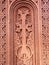 An intricate doorway with a Celtic cross woven in the design