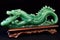 intricate dragon carving on vibrant green jade