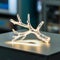 Intricate, glowing tree branch shaped object on a flat surface in industrial setting