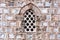 Intricate Islamic Stone Window with Ornate Details on Mosque Facade