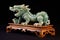 intricate jade dragon on wooden stand