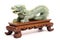 intricate jade dragon on wooden stand