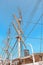 The Intricate Network of Ropes and Pulleys on a Tall Ship under a Clear Blue Sky