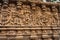 intricate stone carvings on a temple wall