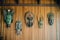 intricate tribal masks hanging on a wooden wall