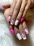 Intricately designed pink and white nails