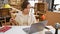 Intriguing portrait of a young, beautiful hispanic woman carpenter, expertly mixing technology and tradition, measuring wood for