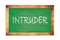 INTRUDER text written on green school board