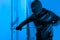 Intruder using crowbar on a door at night