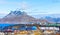 Inuit houses and cottages scattered across tundra landscape in residential suburb of Nuuk city with fjord and mountains in the