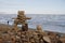 Inukshuk or Inuksuk on a rocky beach with ice on the ocean in late June in the high arctic