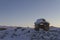 Inuksuk landmark covered in snow found on a hill near the community of Cambridge Bay