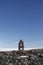 Inuksuk landmark with frozen bay in the background