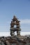 Inuksuk landmark with frozen bay in the background