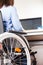 Invalid or disabled woman sitting wheelchair working office desk computer