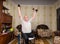 Invalid old man puts his hands up with dumbbells