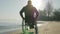 Invalid rides along beach in wheelchair, disabled faith in future, man